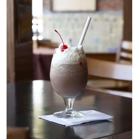 Glass Filled with White Paper Straws and a Glass of Green Juice Beside it with a White Straw in it.